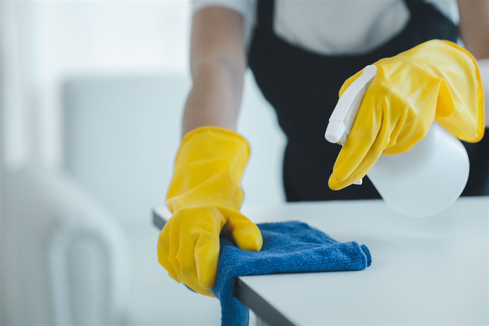 Connect Cleaning team member cleaning an office desk